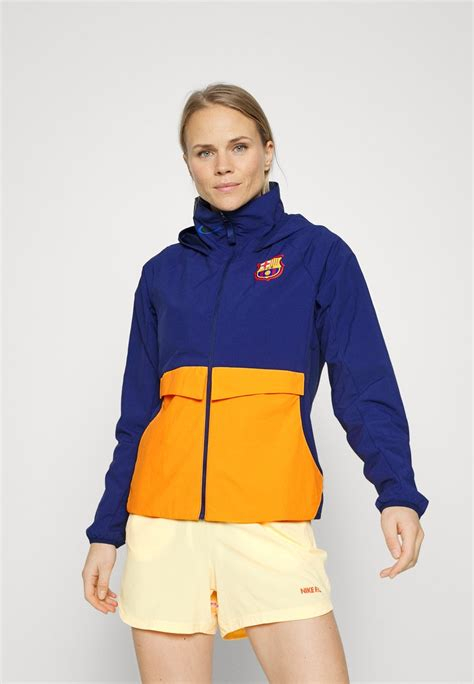 Women COAT | Nike Performance FC BARCELONA - Training jacket - blue void/vivid orange/black/blue - BY27696 Nike Performance blue void/vivid orange/black N1241F09B-K11 0 en-GB